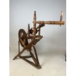 An antique spinning wheel. H:97cm