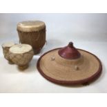 Two bongo drums together with a straw and leather trimmed Hat from the Dogon people, Mali W:58cm Hat