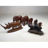 An East African set of 5 graduated carved wood elephants and a rhinoceros. Damage to tip of rhino'