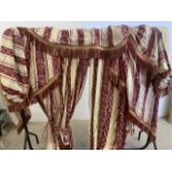 A Pair of stripy curtains with corded tie back and fringed swags fringed pelemet. Some fading to