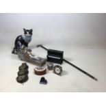 A painted iron cat door stop, also with a figure of Cleopatra, a pewter topped walking stick, a