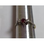 An 18 carat gold diamond and ruby ring. Total weight 2 gm. Size 7