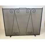 A large, hand-crafted wrought iron fire screen. Of rectangular form with scroll design.