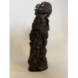 A West African carved ebony figure of a mother and children. (3) H:34cm