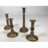 A pair of telescopic brass candlesticks together with a pair stamped H to base H:26cm Extended