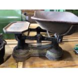 A pair of part painted cast iron scales also with two flat irons, a small cauldron, weights and