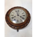An Ansonia wall clock in wooden case with painted metal face W:23cm x D:9cm x H:23cm