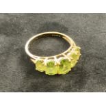 A 9ct gold peridot five stone ring. Size R.