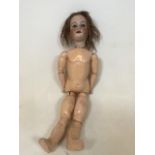 An Armand Marseille doll with teeth and closing eyes. Porcelian head. H:70cm