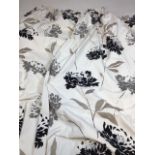A pair of printed lined floral curtains in black and grey design with highlights of silver W:165cm x
