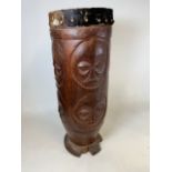 An African Zulu tribal hardwood tall drum, carved with faces. With taut goat skin drumhead. Circa