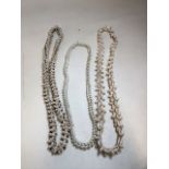 Three long heavy Cowrie shell necklaces. Longest is approx 136cm