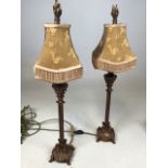 A pair of decorative lamps with gold metal bases and fully lined shades W:20cm x H:65cm