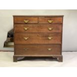 Late Georgian oak chest of 2 short, and 3 long drawers. With brass bail handles, standing on bracket