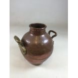 A hand beaten copper pot with brass handles. W:27cm x H:30cm