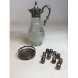 A moulded glass silver plated claret jug together with plated salt and pepper pots and a wine
