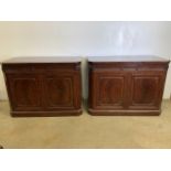 A pair of George III style mahogany side cabinets, each fitted with two frieze drawers above a