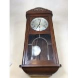 A cased wall clock with metal face - Kemp Bros , Union Street Bristol with leaded bevel edge glass