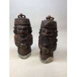 A pair of Eastern carved wooden figural door stops W:14cm x H:31cm