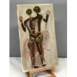 Tribal figures painted on stretched cotton frame. Red and gold palette. In good condition.