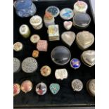 A collection of pill boxes and trinket boxes.