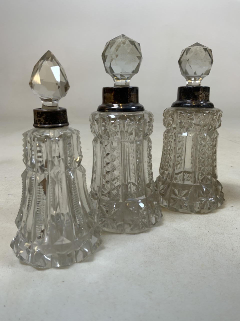 Three Silver topped cut glass scent bottles also with a pair of silver topped vases. - Image 3 of 4