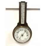 An early 20th century oak short aneroid barometer and thermometer. H:50cm