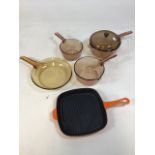 3 glass Vision saucepans with frying pan, and a KK heavy enamel over cast iron skillet, in the