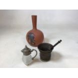 A glass whisky noggin with white metal lid, a brass mortar and pestle and a terracotta bootleg