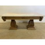 A Marble topped coffee table with carved base with twin pedestals with eight brass lion head mounts.