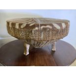 A Large African Zebra skin drum with three legs. W:86cm x D:89cm x H:50cm