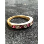 18ct gold half eternity ring with a,ternating rubies and diamonds . Ring size 0/P. Total weight 4gm