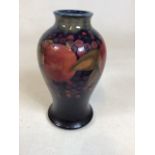 A Moorcroft Pomegranate vase on blue ground. Impressed Moorcroft and signed in green W:12cm x H: