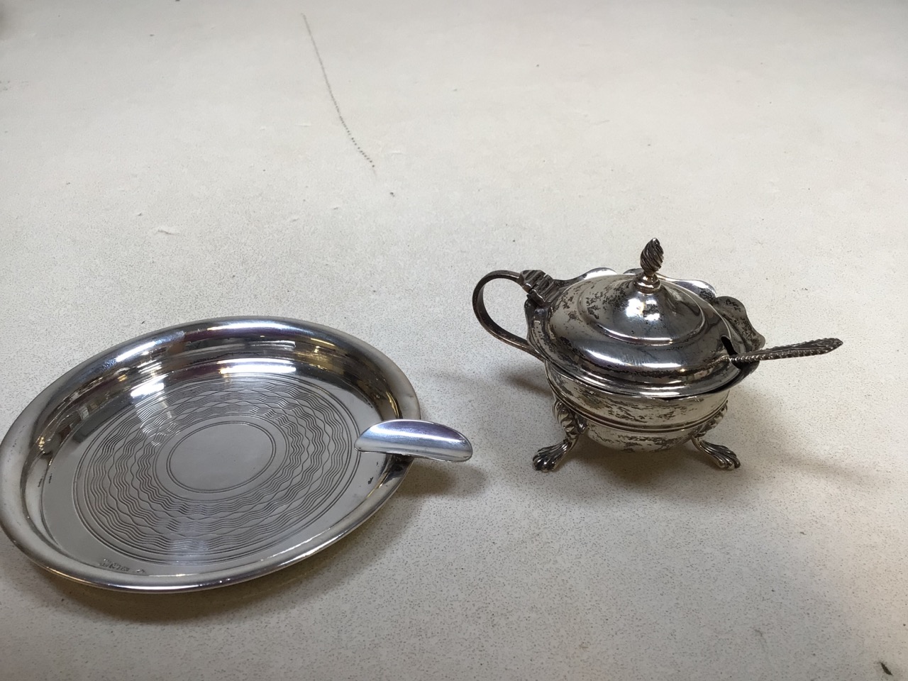 A silver salt ( with blue glass liner) together with a silver ashtray. Total weight of silver 94 gms