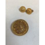 An Ethiopian gold pendant brooch and matching earrings, modelled as traditional Ethiopian hats in