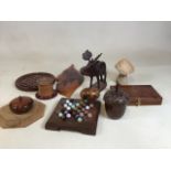 A quantity of treen items includes a Mouseman style board, a spice pot (a/f ), solitaire boards, and