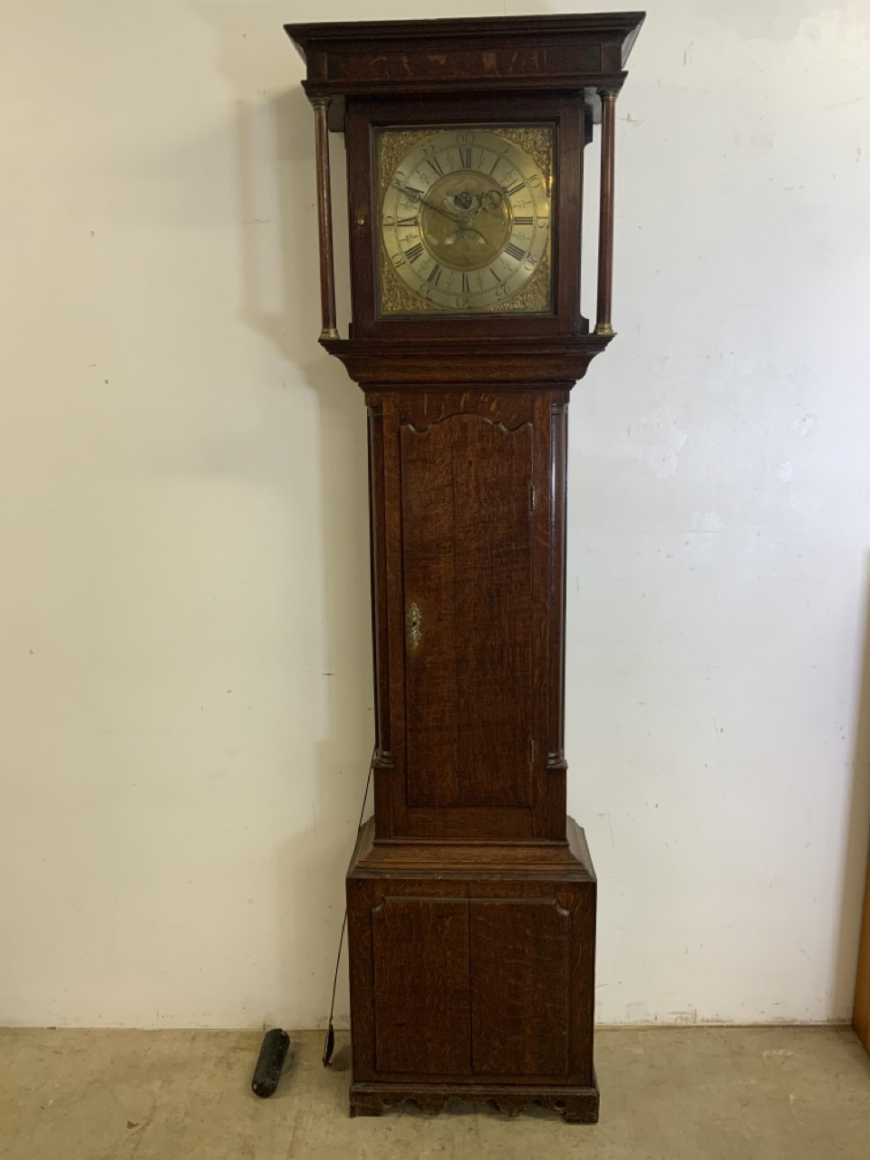 A Thomas Lister Georgian oak longcase clock with weight and pandulum. Brass face with later but