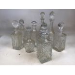 Nine glass decanters of varying designs H:36cm Height of tallest