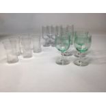 A quantity of vintage glasses including four uranium style wine glasses, engraved cordial glasses