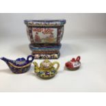 A Chinese planter and stand also with small Oriental tea pots