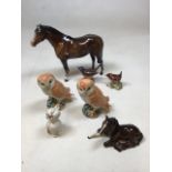 A pair of Beswick owls, a seated cat, a seated foal and other Beswick items. Horse and birds have