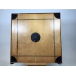 A vintage Carrom board (Indian snooker):with fabric pockets with red and green wooden counters,