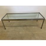 A chrome and glass late 20th century designer style coffee table. W:114cm x D:46cm x H:36cm