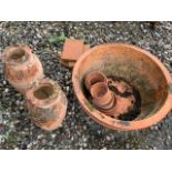 A large terracotta planter a pair of urns also with a selection of smaller pots. Largest W:54cm x