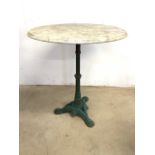 A circular garden table with metal base. a.f the top is not connected to base.