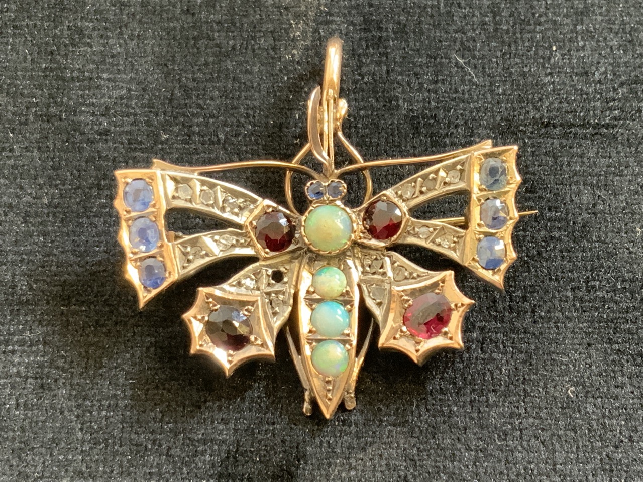 A gold 1920 30’s Butterfly brooch pendent, un-hallmarked set opals, rubies, sapphires and diamonds.