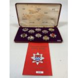 A Cased set of London Fire Brigade Historic Badges. With reference book.