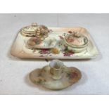 A Royal Worcester blush ivory dressing set with tray, ring stand, candle holder and two lidded