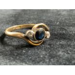 18ct gold sapphire ring flanked with 2 diamonds. Total weight 3 gm. Size O