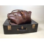 A hide suit case together with a leather hold-all